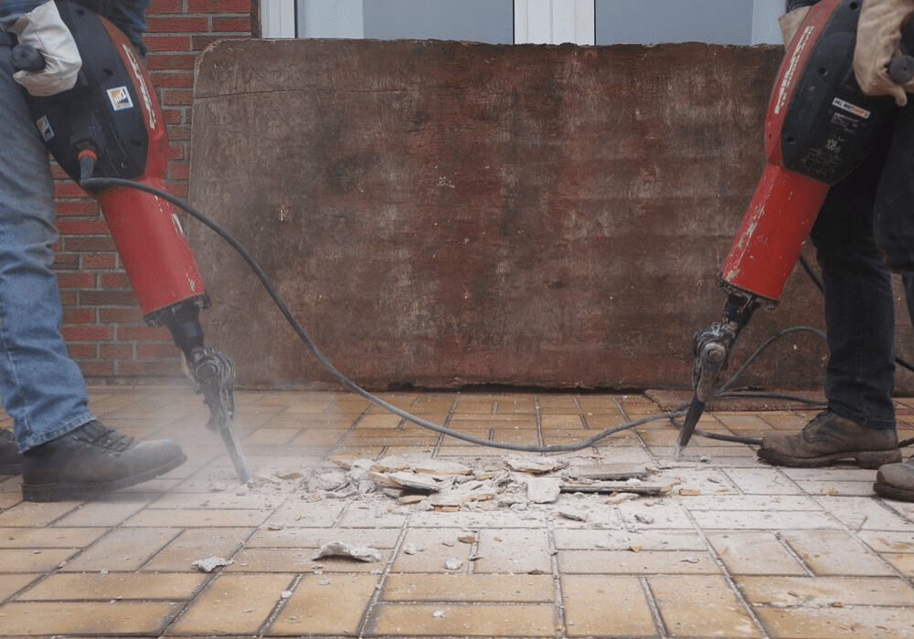 jackhammers breaking up tile floor