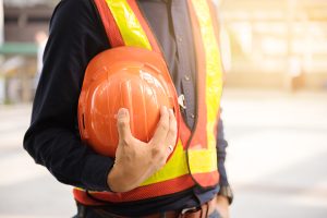 construction worker holding hardhat